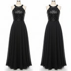 Woman wearing a black evening gown with sequin top in a fitting room.