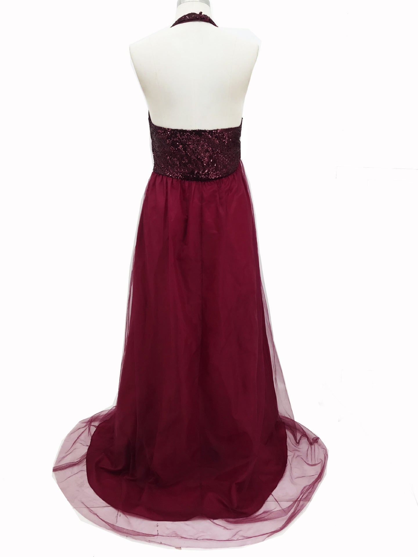 Burgundy evening gown on a mannequin against a white background
