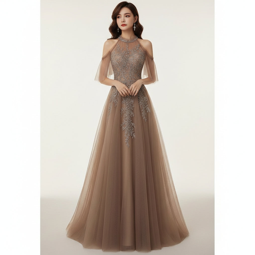 Woman in a brown evening gown with intricate detailing in a dimly lit room.