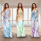 Three women wearing tie-dye maxi dresses on a white background