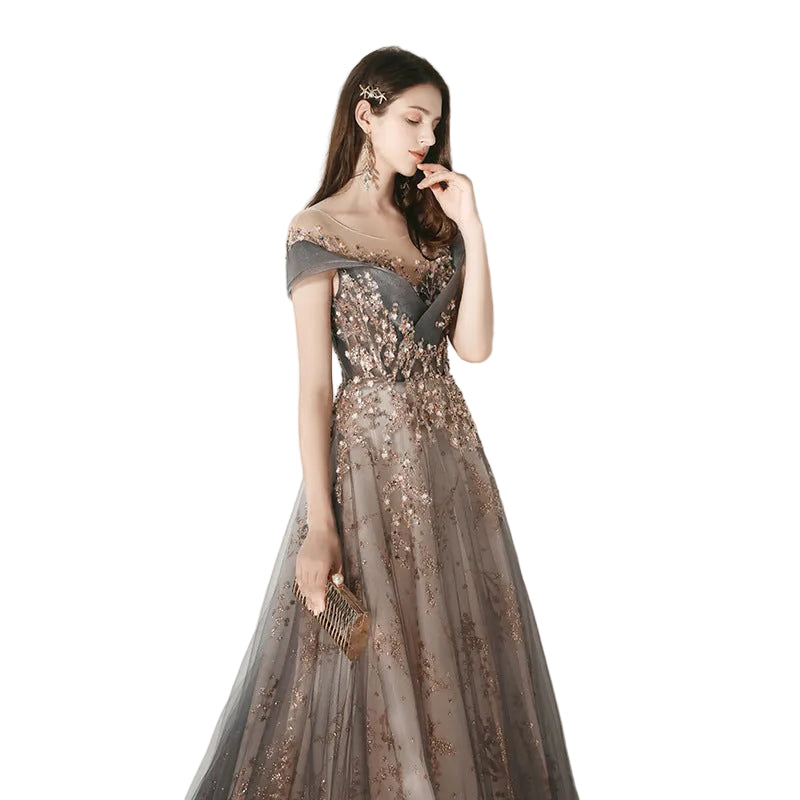 Woman in a glamorous evening gown with sequin details against a plain background