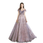 Woman wearing a purple evening gown with floral details on a white background